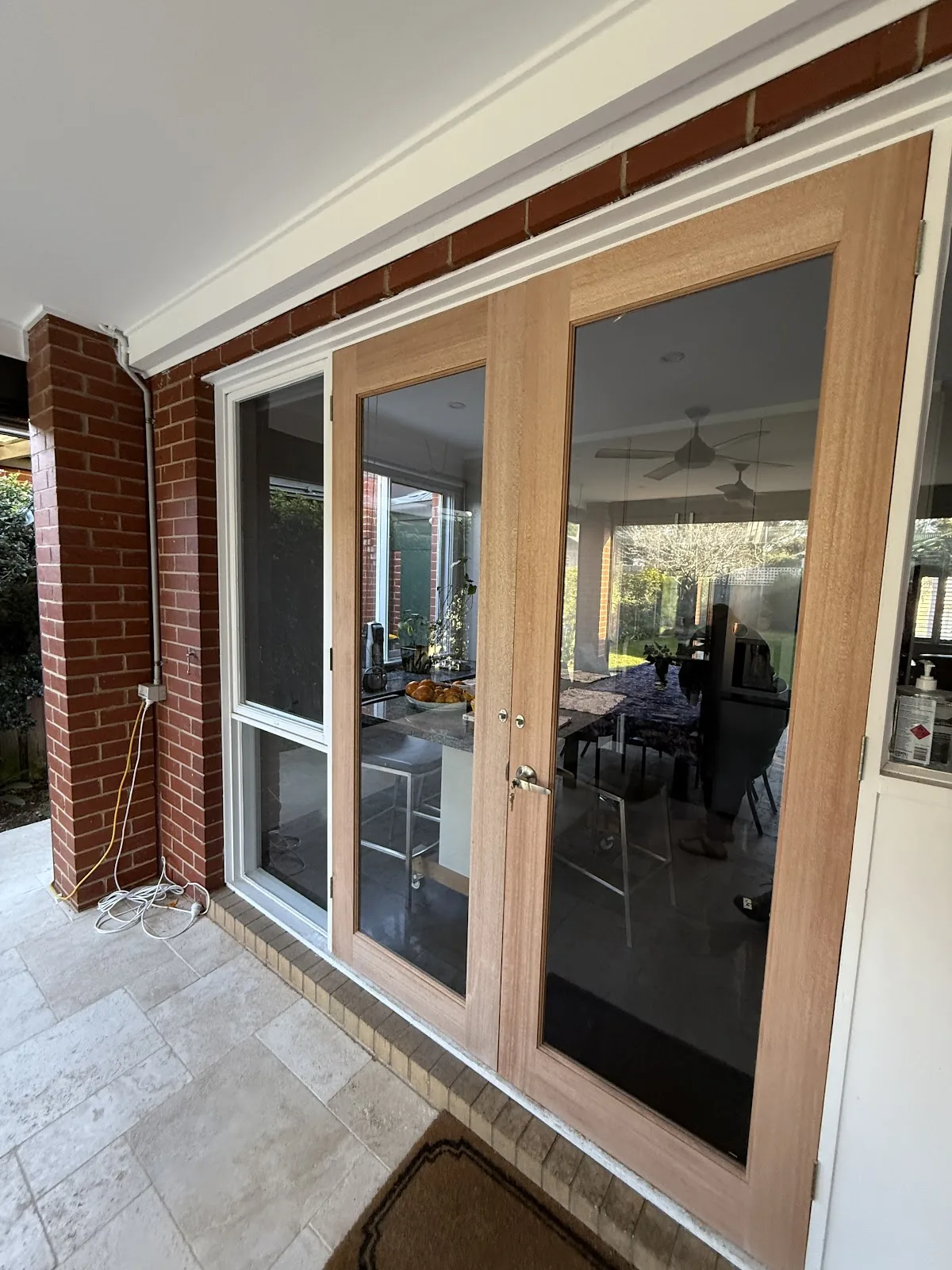 Timber French doors fitted with clear security screens