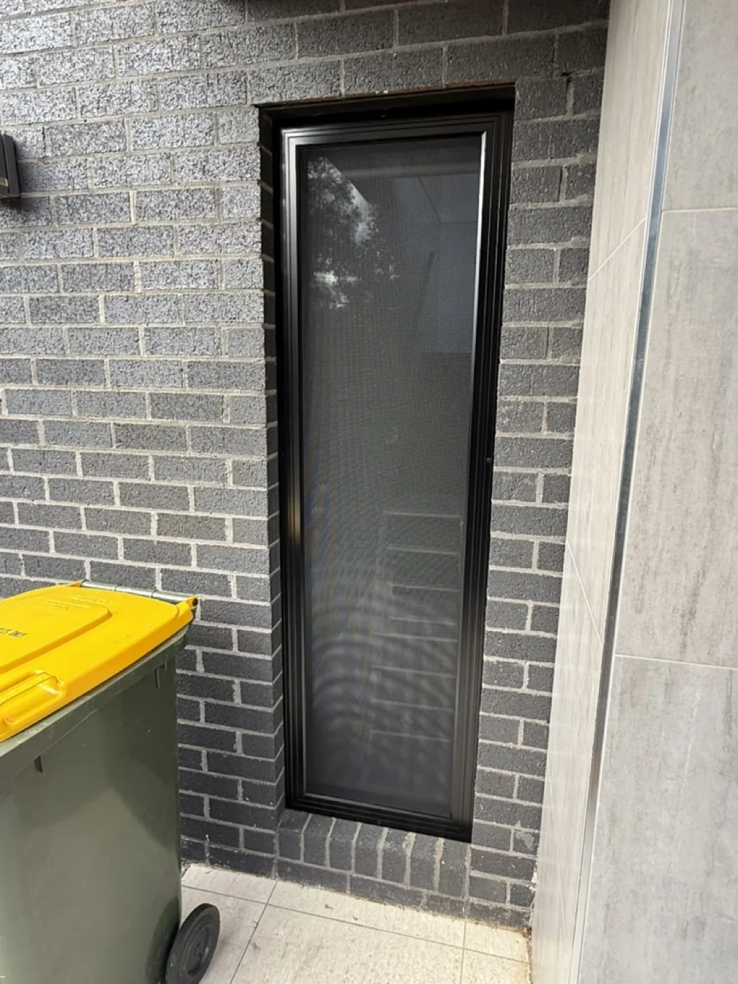 Window security grille with 316 stainless steel mesh on bluestone brick