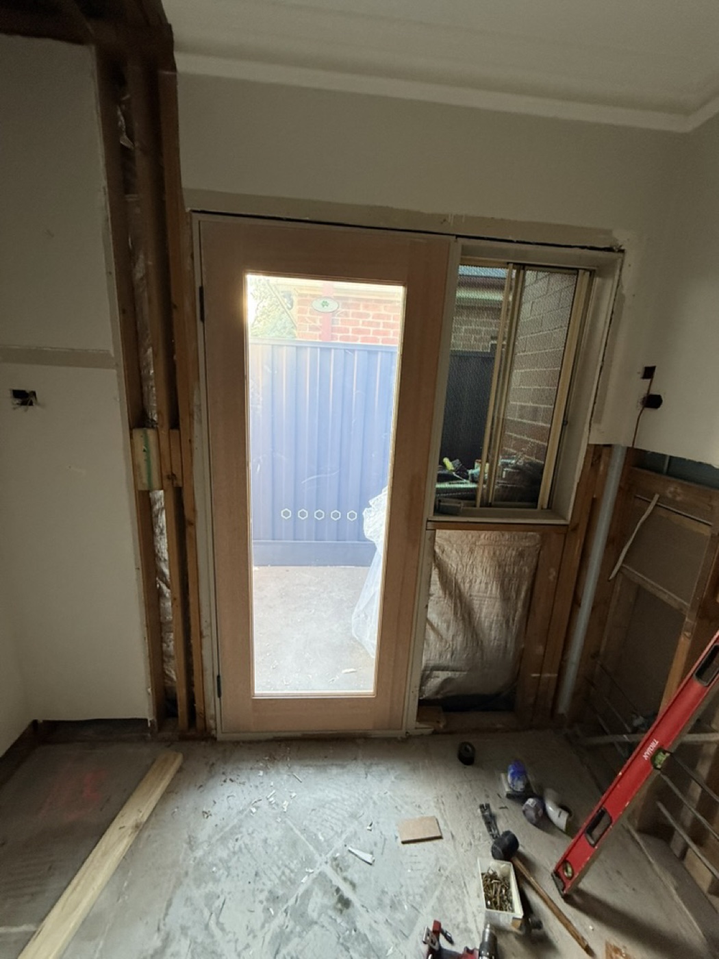 Old aluminium door opening reframed during replacement