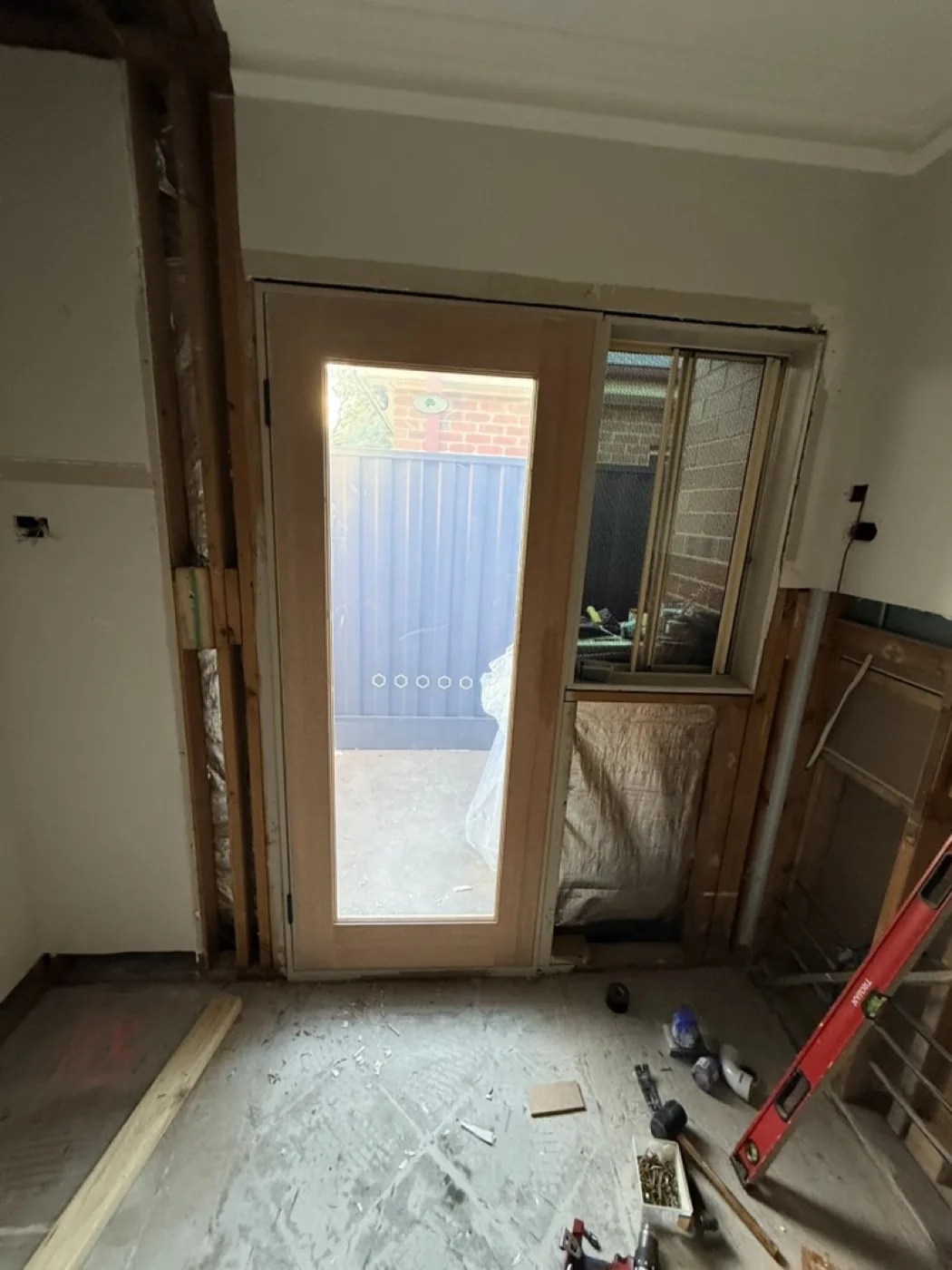 Old aluminium door opening reframed during replacement