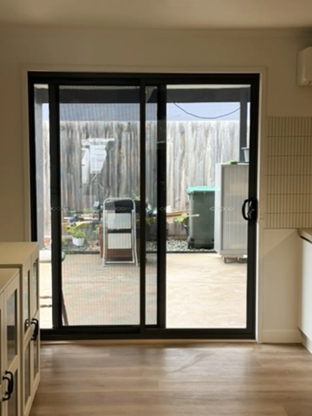 New black aluminium sliding glass door seen from inside the kitchen